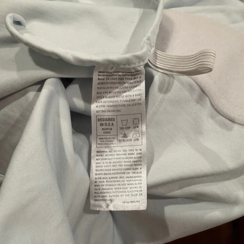 The Ollie Swaddle Adjustable Baby Wrap Light Blue Moisture Wicking Jersey
